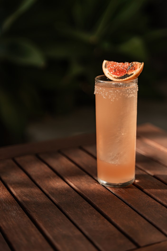 Peach cocktail on a table outdoors with grapefruit slice Hersonissos