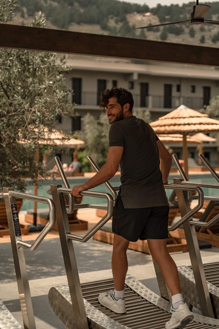 Man Exercising On A Treadmill By The Pool At Cook's Club Kolymbia Rhodes