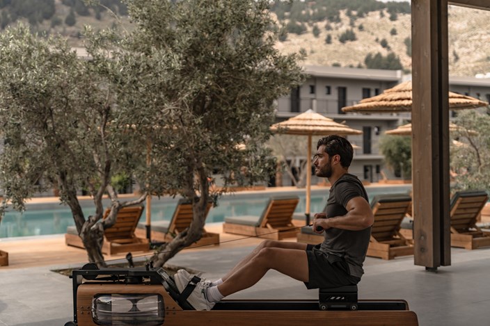 Man Exercising On Rowing Machine In Outdoor Gym At Cook's Club Kolymbia Rhodes